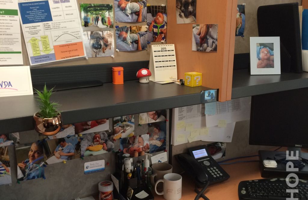 Desk w/ Photos of Cole - Manufacturing Hope